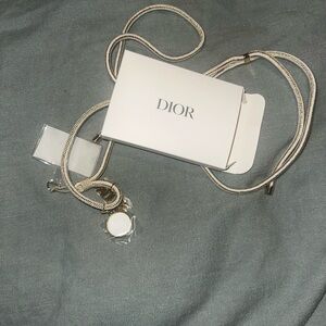 Dior Holiday ‘25 phone accessory with charm